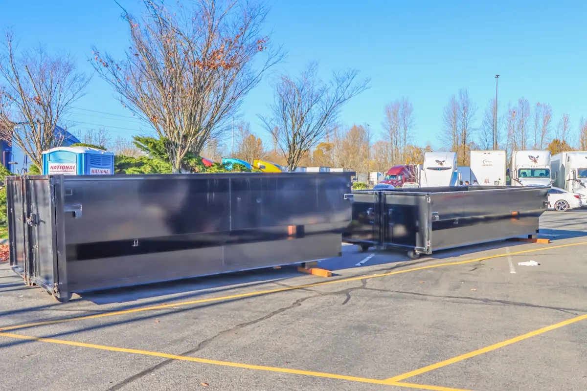 Professional dumpster rental service with roll-off container on residential driveway in Orinda